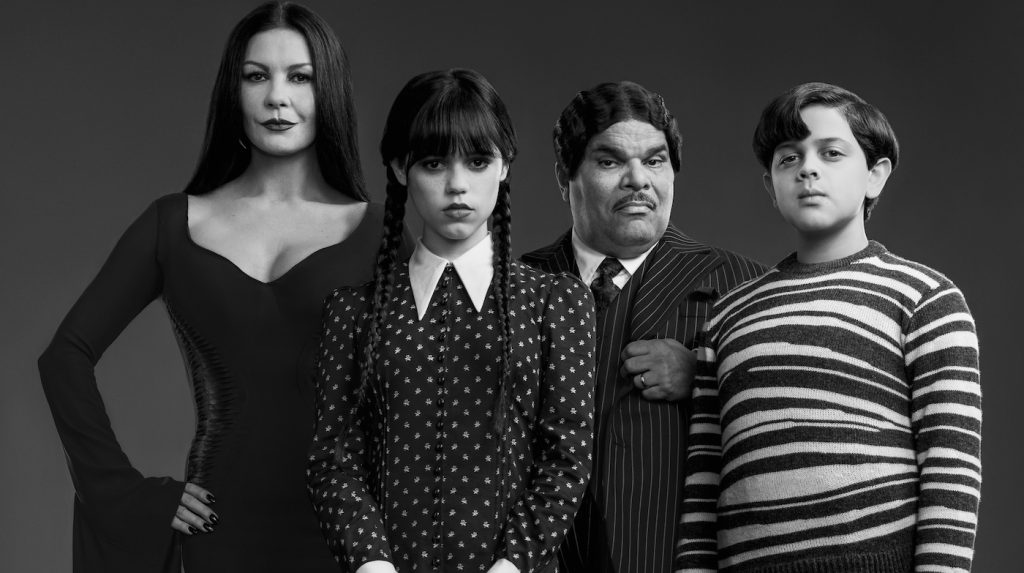 Wednesday. (L to R) Catherine Zeta-Jones as Morticia Adams, Jenna Ortega as Wednesday Addams, Luis Guzmán as Gomez Addams, Issac Ordonez as Pugsley Addams in Wednesday. Cr. Courtesy of Netflix © 2022