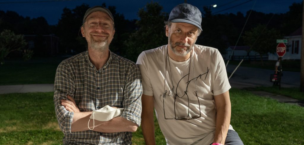 Writer David Kajganich (left) and director Luca Guadagnino (right) on the set of BONES AND ALL, a Metro Goldwyn Mayer Pictures film.  Credit: Yannis Drakoulidis / Metro Goldwyn Mayer Pictures  © 2022 Metro-Goldwyn-Mayer Pictures Inc.  All Rights Reserved.