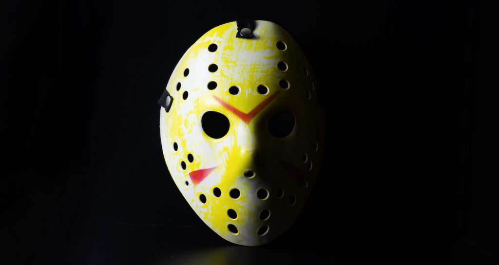 Mask of maniac Jason Voorhees from Friday the 13th movie on black background