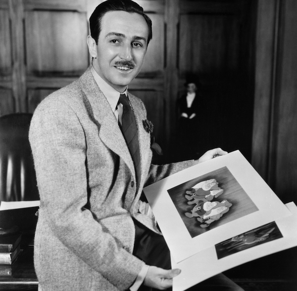 Walt Disney holding cels from Walt Disney’s animated feature Snow White and the Seven Dwarfs. Courtesy Walt Disney Studios