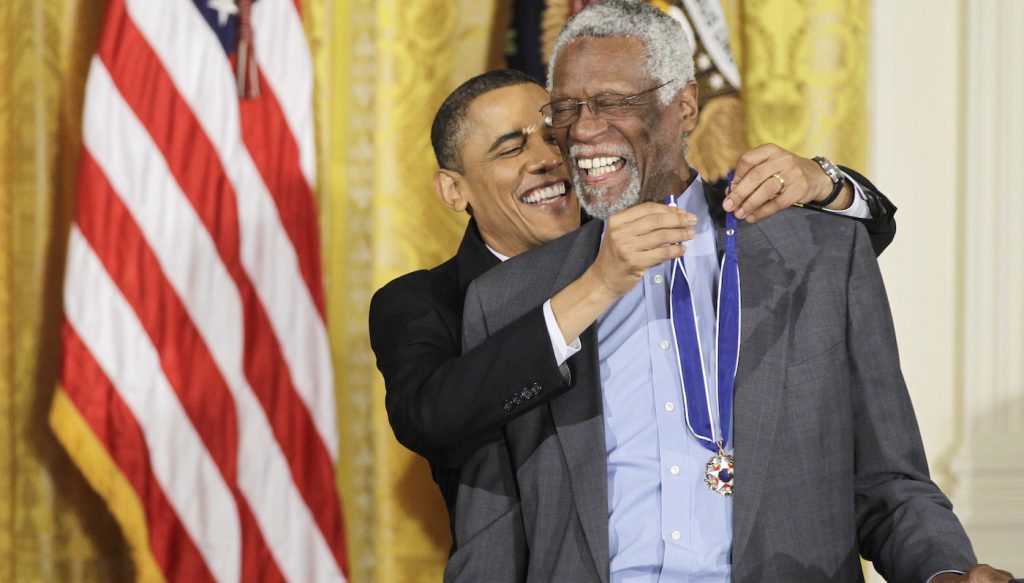 President Barack Obama reaches up to present a 2010 Presidential Medal of Freedom to basketball hall of fame member, former Boston Celtics coach and captain Bill Russell, Tuesday, Feb. 15, 2011, during a ceremony in the East Room of the White House in Washington. Cr. Charles Dharapak/AP Images/Courtesy of Netflix