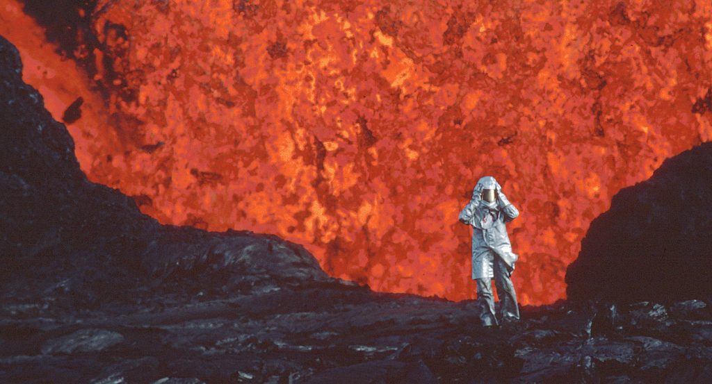 Katia Krafft wearing aluminized suit standing near lava burst at Krafla Volcano, Iceland. (Credit: Image'Est)